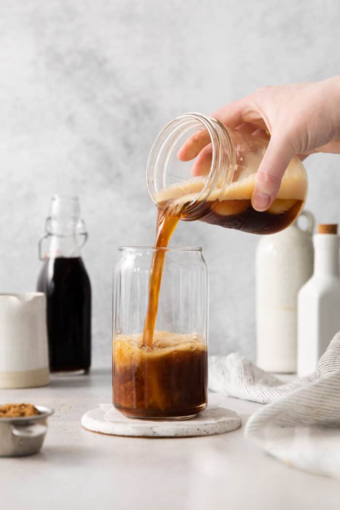 Made with just 4 ingredients, this Iced Brown Sugar Oatmilk Shaken Espresso tastes just like the Starbucks version! Shaken espresso being poured into a glass