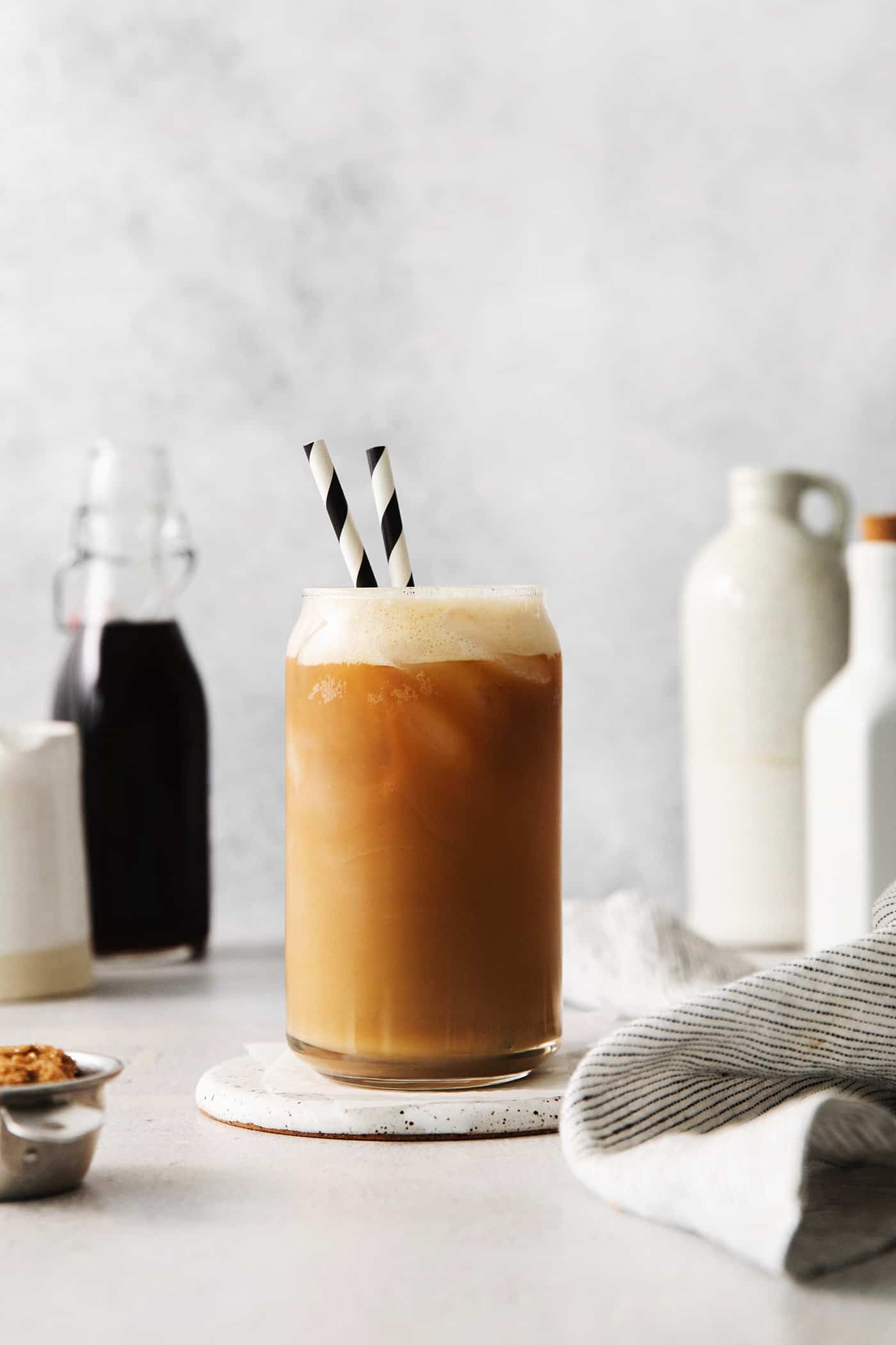 Made with just 4 ingredients, this Iced Brown Sugar Oatmilk Shaken Espresso tastes just like the Starbucks version! A copycat Starbucks oatmilk shaken espresso in a glass with two straws