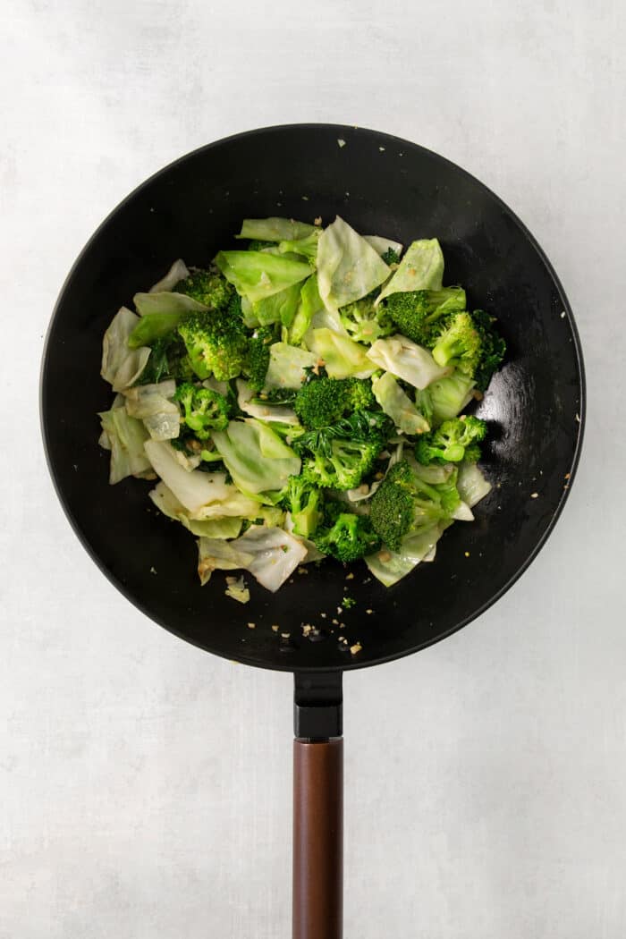 Panda Express Super Greens are a fresh, bright, feel-good side dish made with broccoli, cabbage, and kale in a light garlic-ginger soy sauce. Steamed veggies in a wok