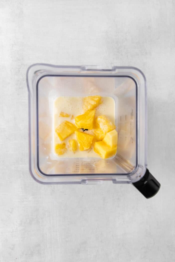 This Classic Pina Colada is fruity and refreshing, with sweet pineapple, a hint of lime, and plenty of rum. The perfect cocktail for summer! Chunks of pineapple and cream of coconut in a blender