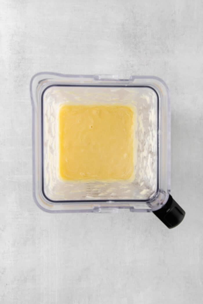 This Classic Pina Colada is fruity and refreshing, with sweet pineapple, a hint of lime, and plenty of rum. The perfect cocktail for summer! Blended pina colada ingredients in a blender