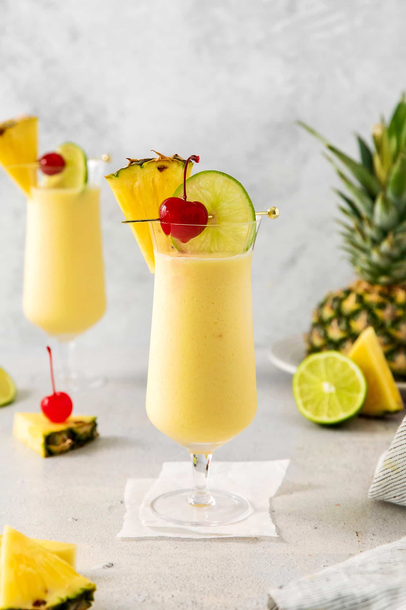 This Classic Pina Colada is fruity and refreshing, with sweet pineapple, a hint of lime, and plenty of rum. The perfect cocktail for summer! Pina colada in a cocktail glass
