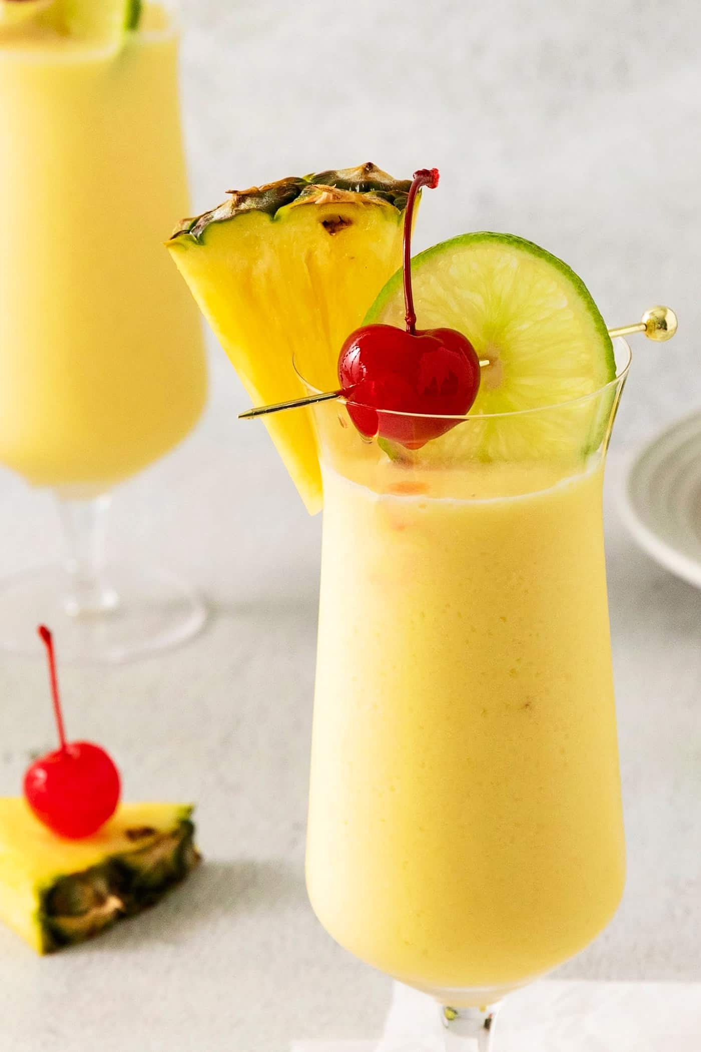 This Classic Pina Colada is fruity and refreshing, with sweet pineapple, a hint of lime, and plenty of rum. The perfect cocktail for summer! Close up of a pina colada cocktail
