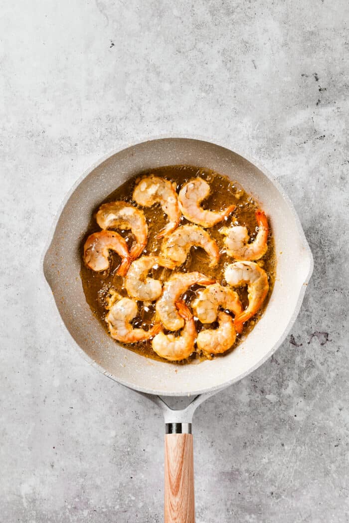With crispy fried shrimp coated in a sticky sweet and spicy sauce, this Firecracker Shrimp is ready in just 25 minutes for an easy dinner. Shrimp in a frying pan