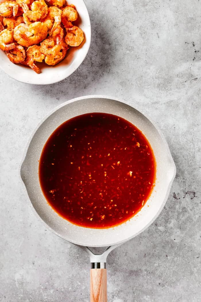 With crispy fried shrimp coated in a sticky sweet and spicy sauce, this Firecracker Shrimp is ready in just 25 minutes for an easy dinner. Firecracker sauce in a skillet