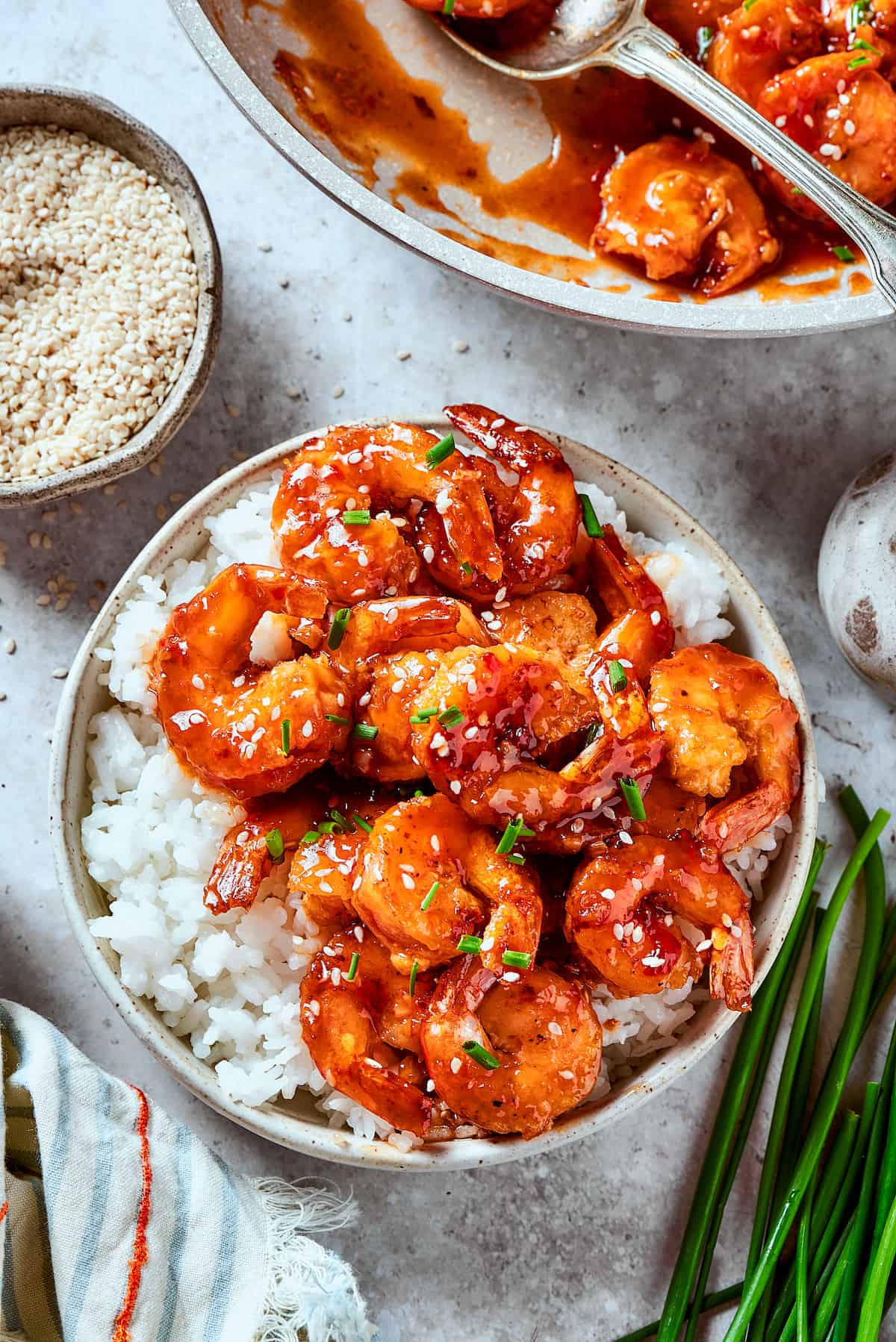 With crispy fried shrimp coated in a sticky sweet and spicy sauce, this Firecracker Shrimp is ready in just 25 minutes for an easy dinner. Overhead view of a bowl of firecracker shrimp with rice