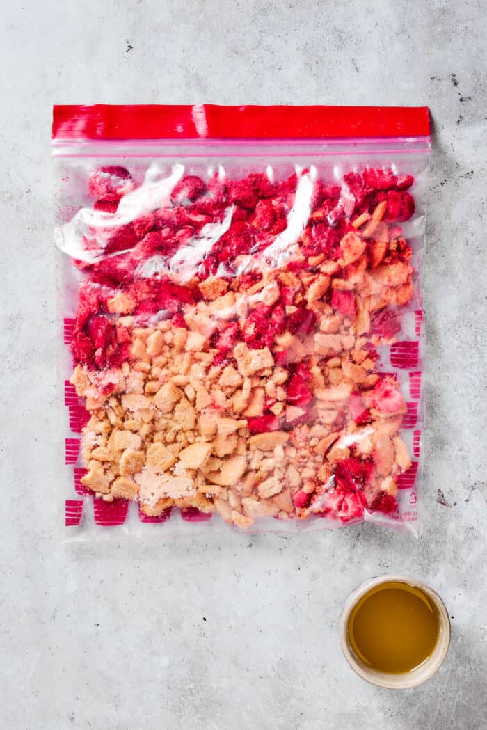 Creamy and sweet with a bit of crunch, Strawberry Crunch Cake is bursting with fruit flavor! This bright strawberry dessert is a favorite. Crushed topping for strawberry crunch cake in a plastic bag.