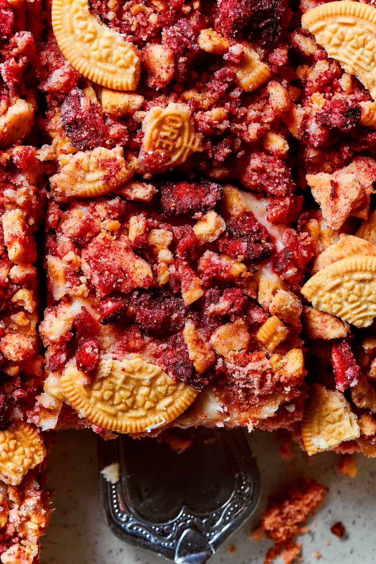 Creamy and sweet with a bit of crunch, Strawberry Crunch Cake is bursting with fruit flavor! This bright strawberry dessert is a favorite. A close-up of strawberry crunch cake.