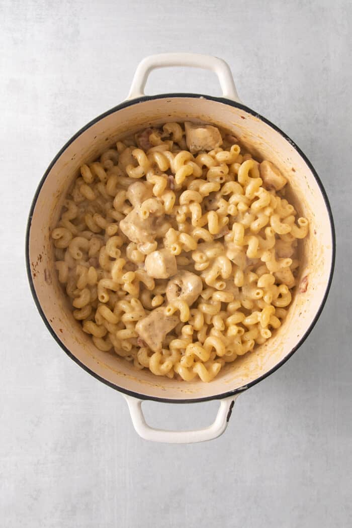 This Chicken Bacon Ranch Pasta is a perfect family-friendly meal loaded with flavor! Bacon, chicken, and pasta are baked in a creamy sauce. The ingredients for chicken ranch pasta are mixed together in a pot.