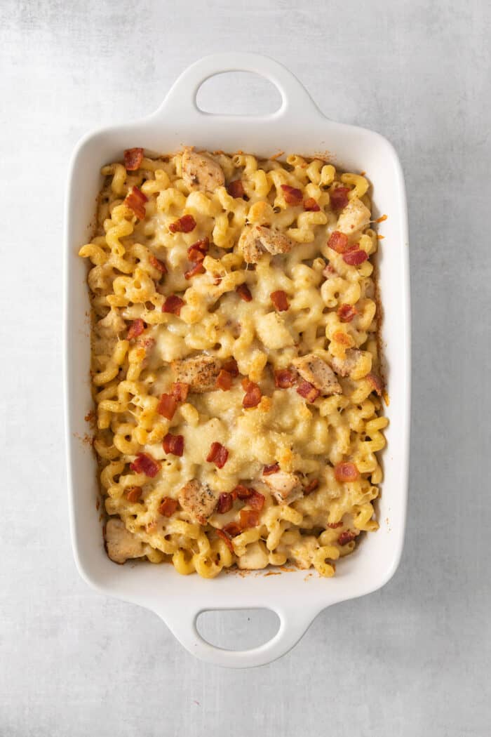 This Chicken Bacon Ranch Pasta is a perfect family-friendly meal loaded with flavor! Bacon, chicken, and pasta are baked in a creamy sauce. A baked dish of chicken ranch pasta.