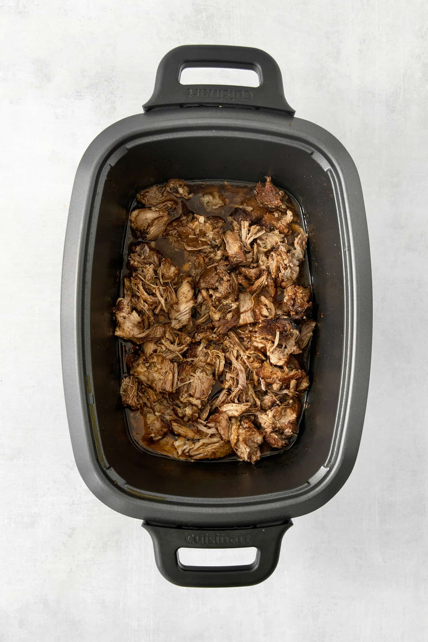 Incredibly tender and a little bit spicy, this easy Pulled Pork recipe is an absolute keeper. It's also super flavorful and versatile. Pork cooks in a slow cooker