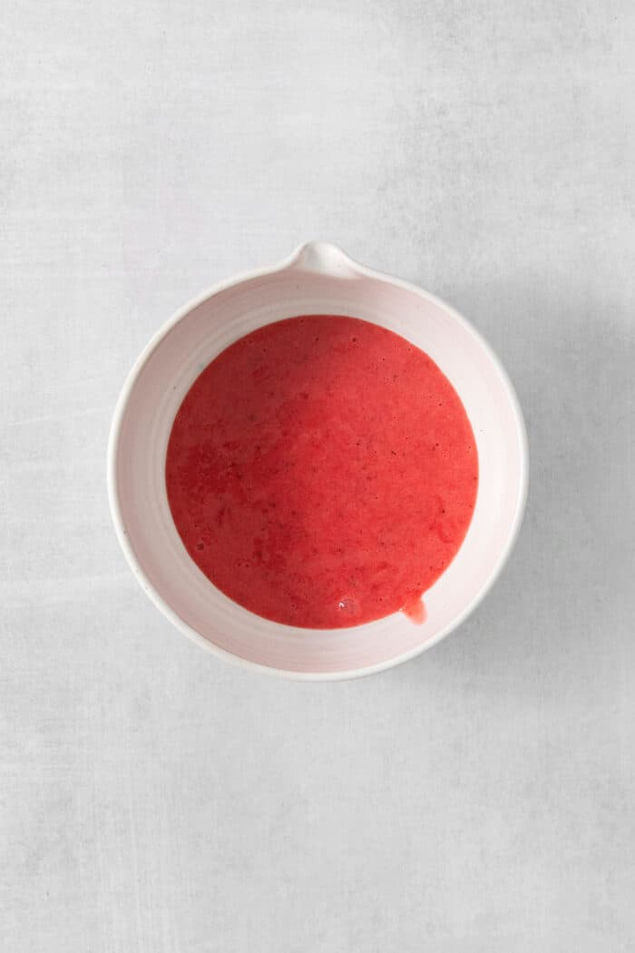 Refreshing and beautiful, Strawberry Milk is beyond simple to make! You'll need just 4 ingredients and a few minutes to whip up glasses of this strawberry-laden drink. A white bowl of strawberry puree.