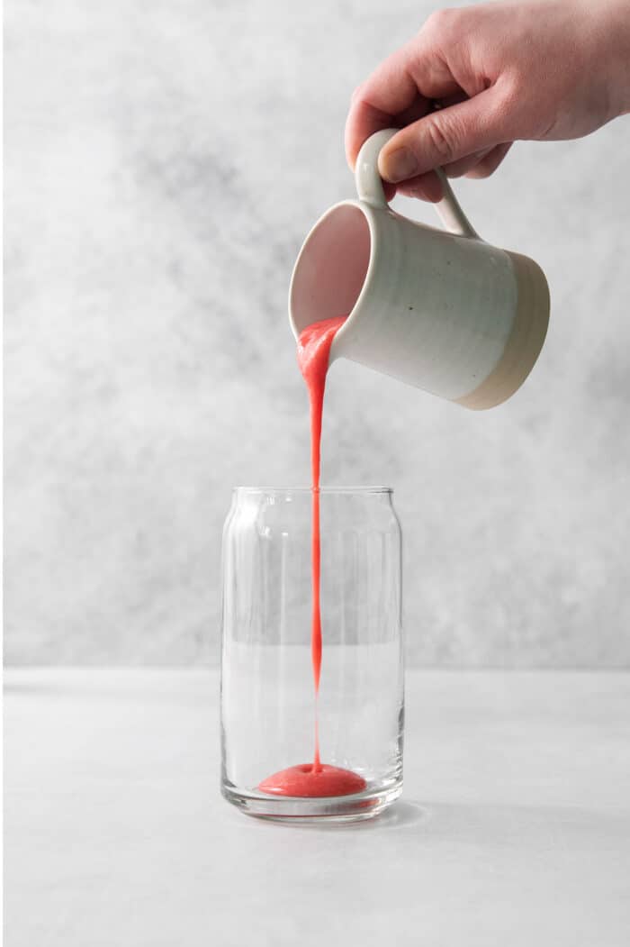 Refreshing and beautiful, Strawberry Milk is beyond simple to make! You'll need just 4 ingredients and a few minutes to whip up glasses of this strawberry-laden drink. Pouring strawberry puree into a glass.