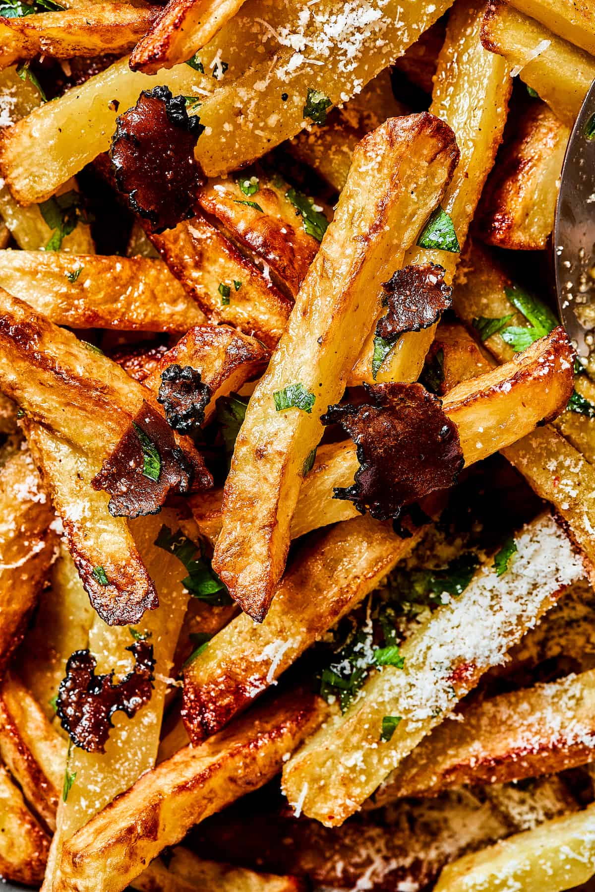 Crispy and flavorful, Truffle Fries may become your new favorite fry! They're touched with truffle salt and a dusting of parmesan cheese. Close up of truffle fries.
