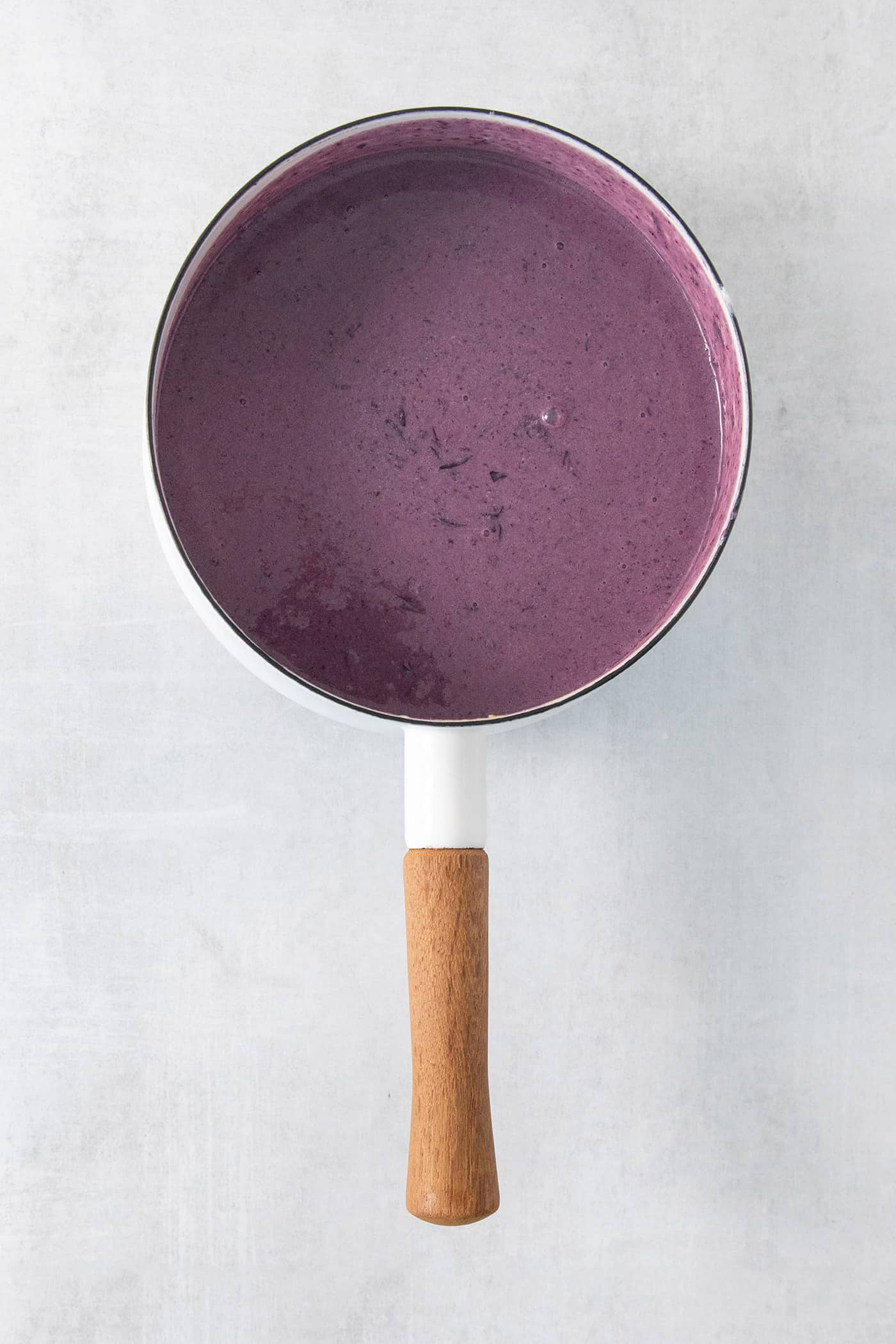 Summer-sweet Crème Fraîche Blueberry Ice Cream swirls roasted blueberries into a creamy ice cream to make the best of blueberry season! Blueberry puree in a pot.