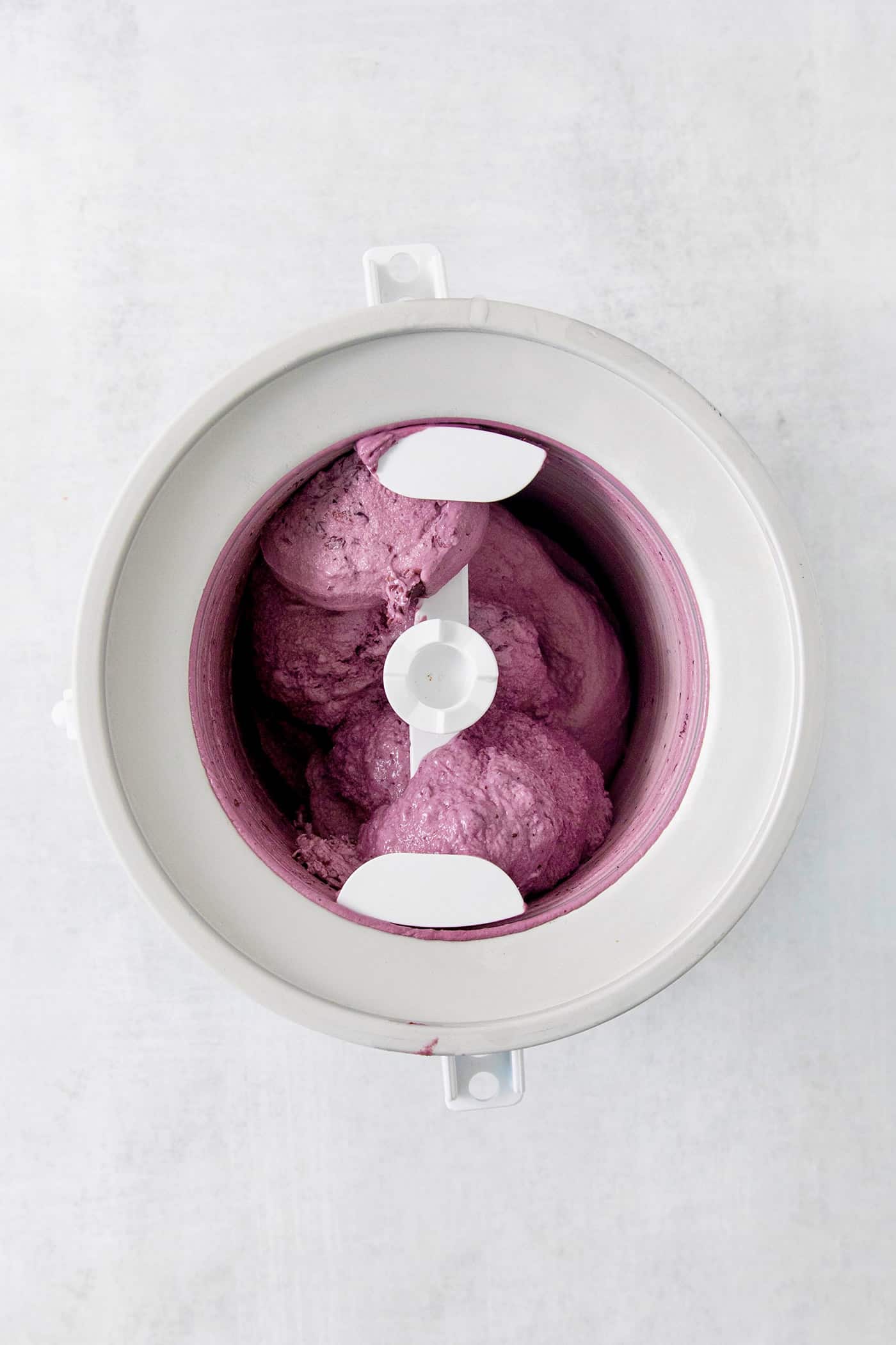 Summer-sweet Crème Fraîche Blueberry Ice Cream swirls roasted blueberries into a creamy ice cream to make the best of blueberry season! Blueberry ice cream cream churns in an ice cream maker.