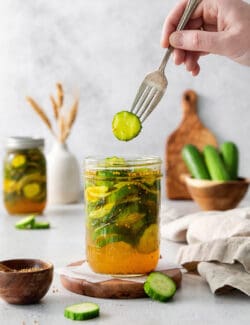 A jar of bread and butter pickles and a fork.