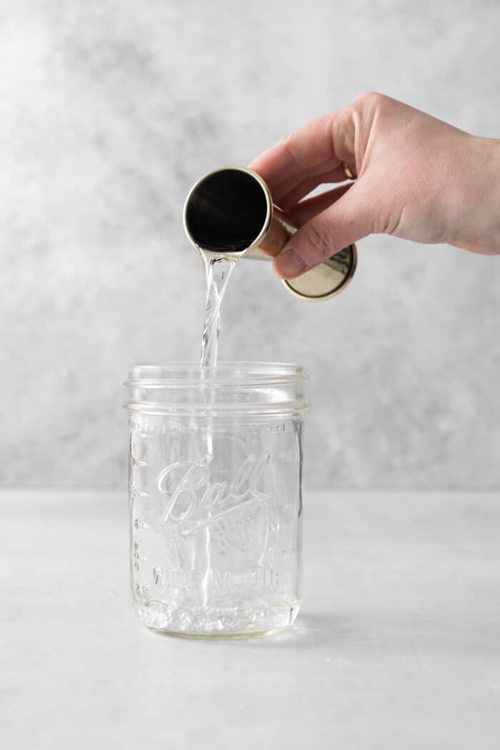 This Classic Daiquiri is an easy and refreshing cocktail you can make with just three ingredients. The perfect balance of sweet and tart! White rum being poured into a mason jar