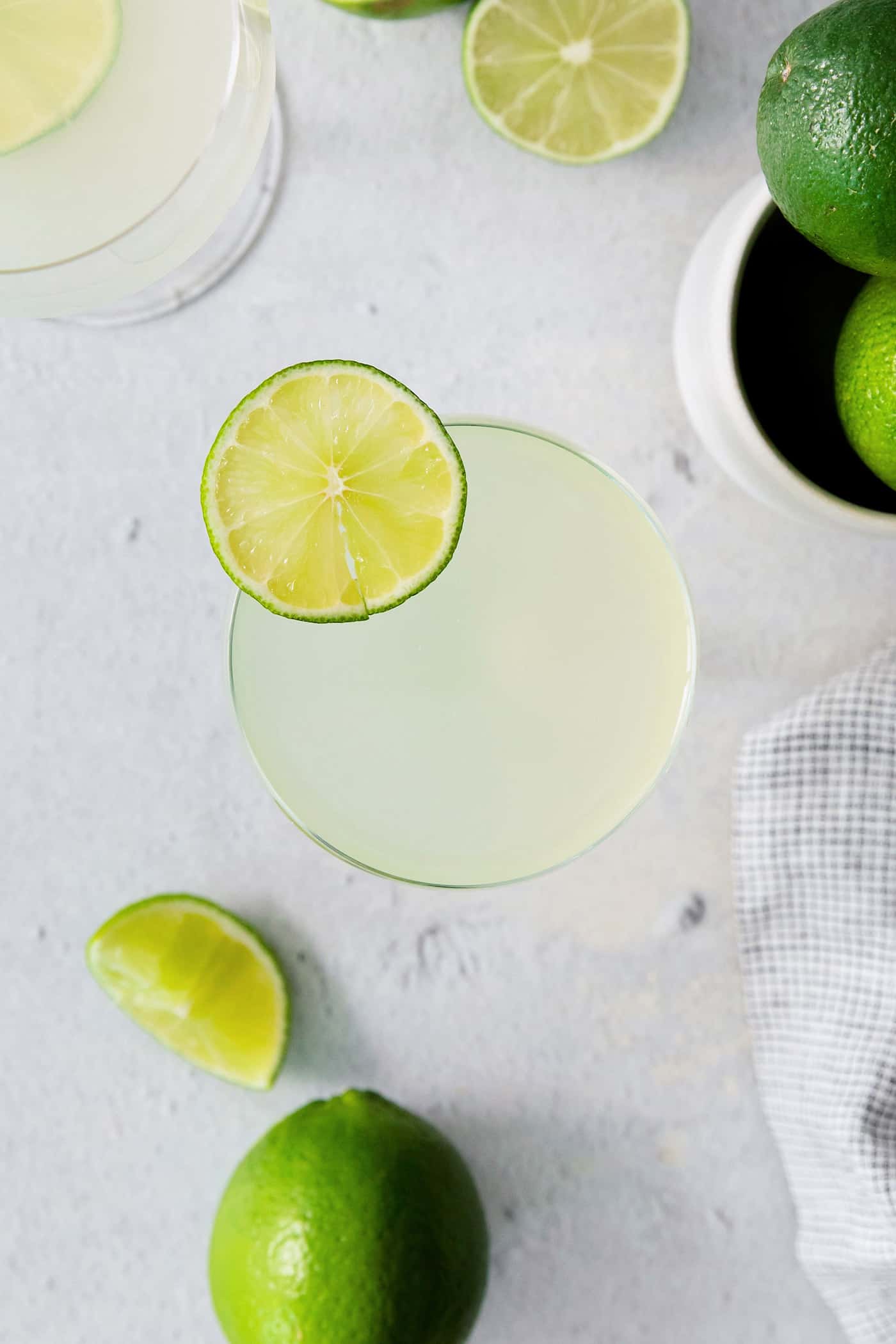 This Classic Daiquiri is an easy and refreshing cocktail you can make with just three ingredients. The perfect balance of sweet and tart! Overhead view of a classic daiquiri drink