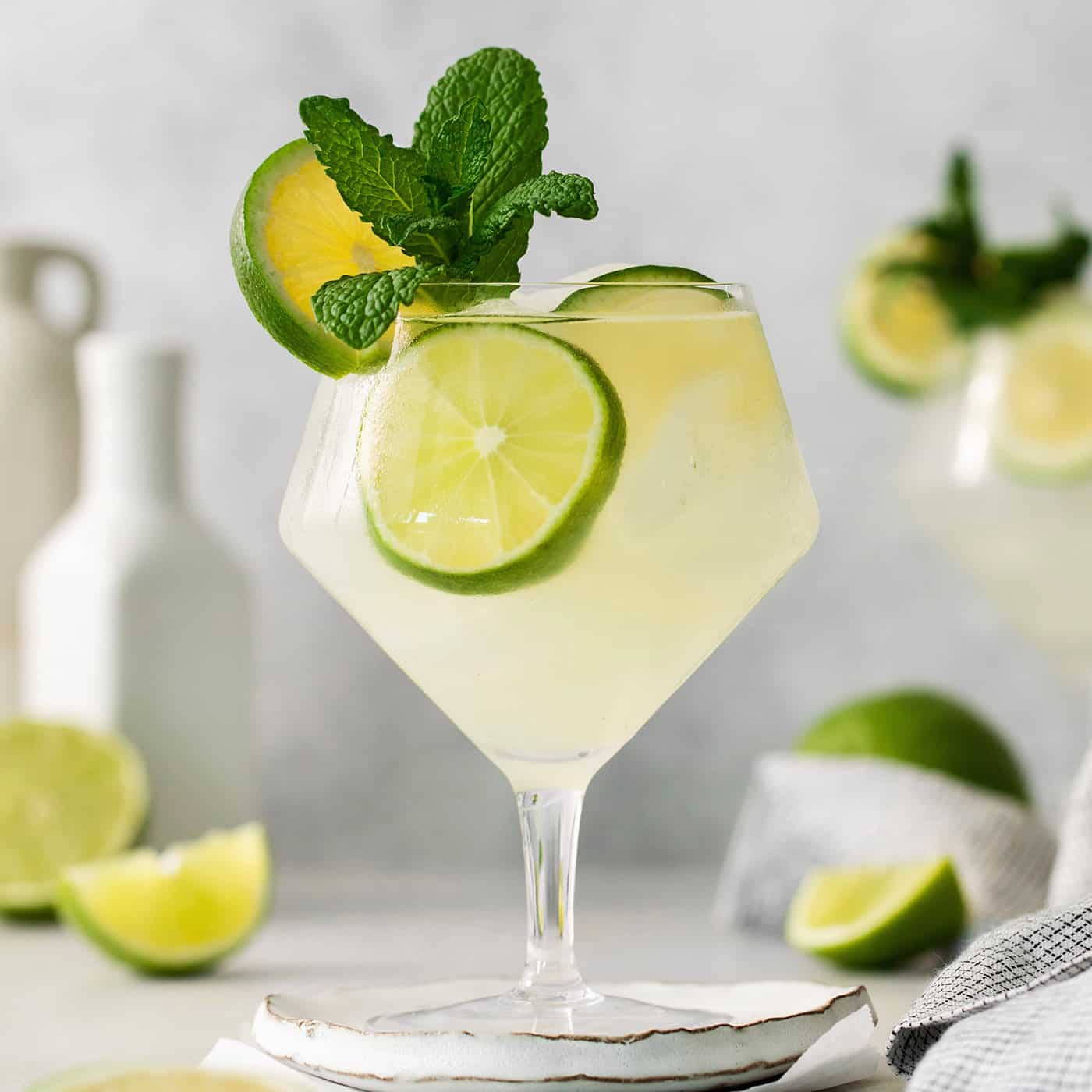 Crisp and refreshing, a Classic Mojito is the only mojito recipe you truly need! Lime juice, mint, and rum make this wonderful cocktail. Classic mojitos are shown in glasses topped with mint and lime.