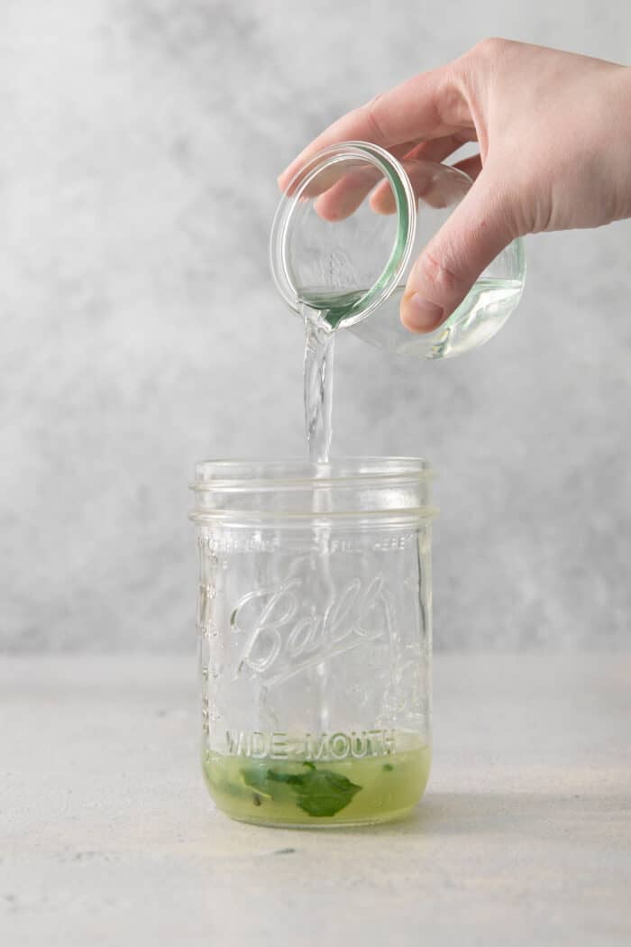 Crisp and refreshing, a Classic Mojito is the only mojito recipe you truly need! Lime juice, mint, and rum make this wonderful cocktail. Lime juice is poured into a jar.