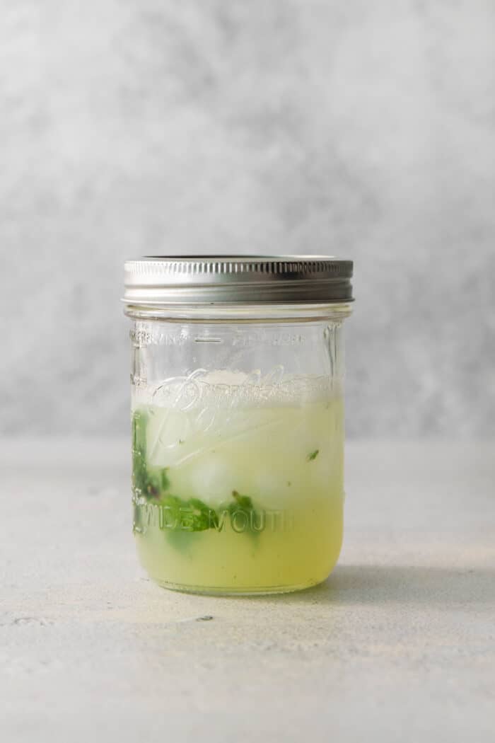 Crisp and refreshing, a Classic Mojito is the only mojito recipe you truly need! Lime juice, mint, and rum make this wonderful cocktail. Mojito ingredients are shown in a jar.