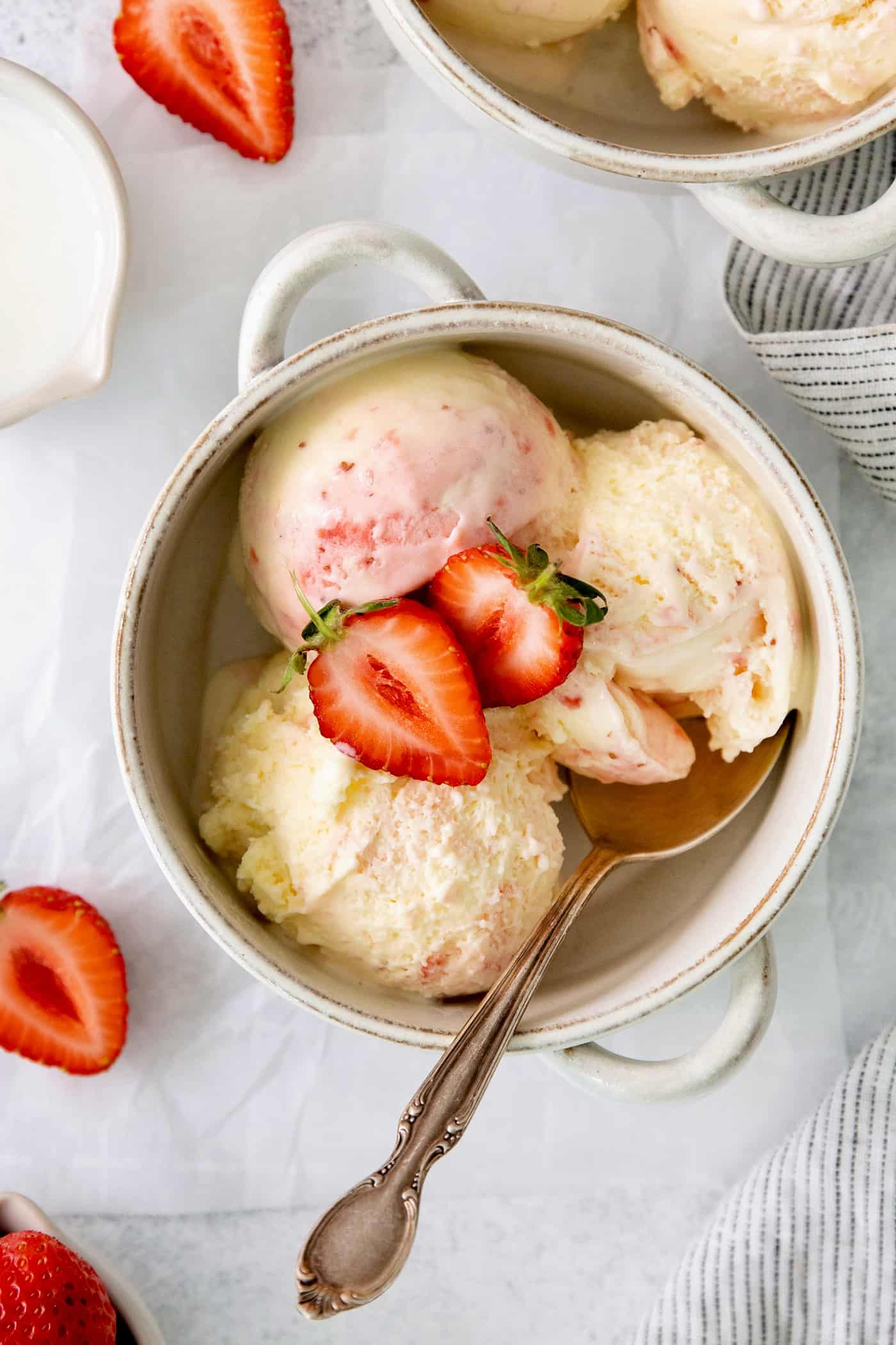 This homemade Crème Fraîche Strawberry Ice Cream is rich and ultra creamy with a gorgeous strawberry swirl folded into a tangy ice cream. A bowl of crème fraîche strawberry swirl ice cream.