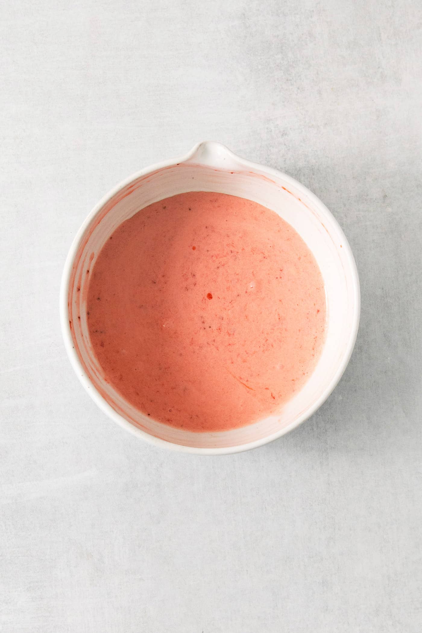 This homemade Crème Fraîche Strawberry Ice Cream is rich and ultra creamy with a gorgeous strawberry swirl folded into a tangy ice cream. A bowl of strawberry puree.