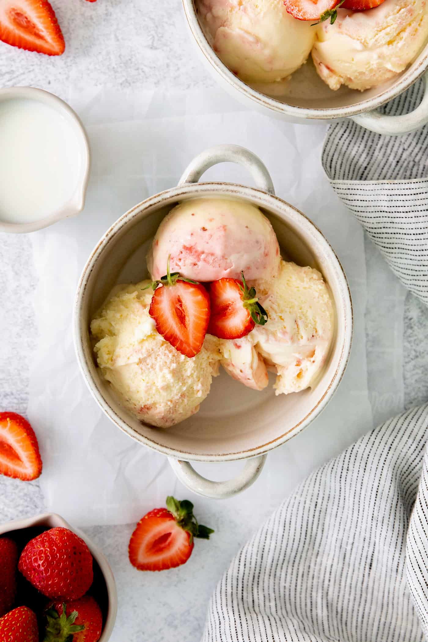 This homemade Crème Fraîche Strawberry Ice Cream is rich and ultra creamy with a gorgeous strawberry swirl folded into a tangy ice cream. A bowl of crème fraîche strawberry swirl ice cream.