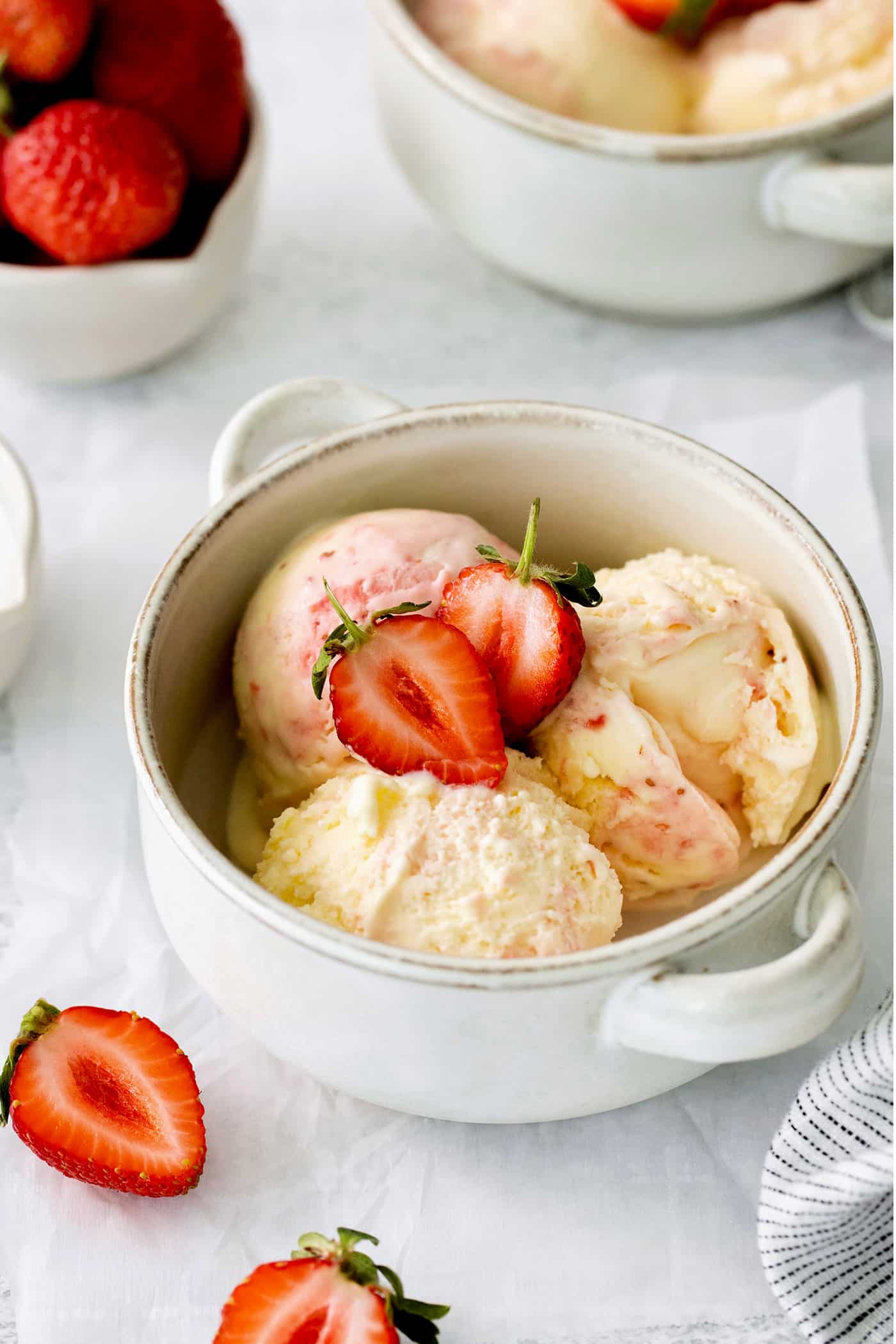 This homemade Crème Fraîche Strawberry Ice Cream is rich and ultra creamy with a gorgeous strawberry swirl folded into a tangy ice cream. A bowl of crème fraîche strawberry swirl ice cream.