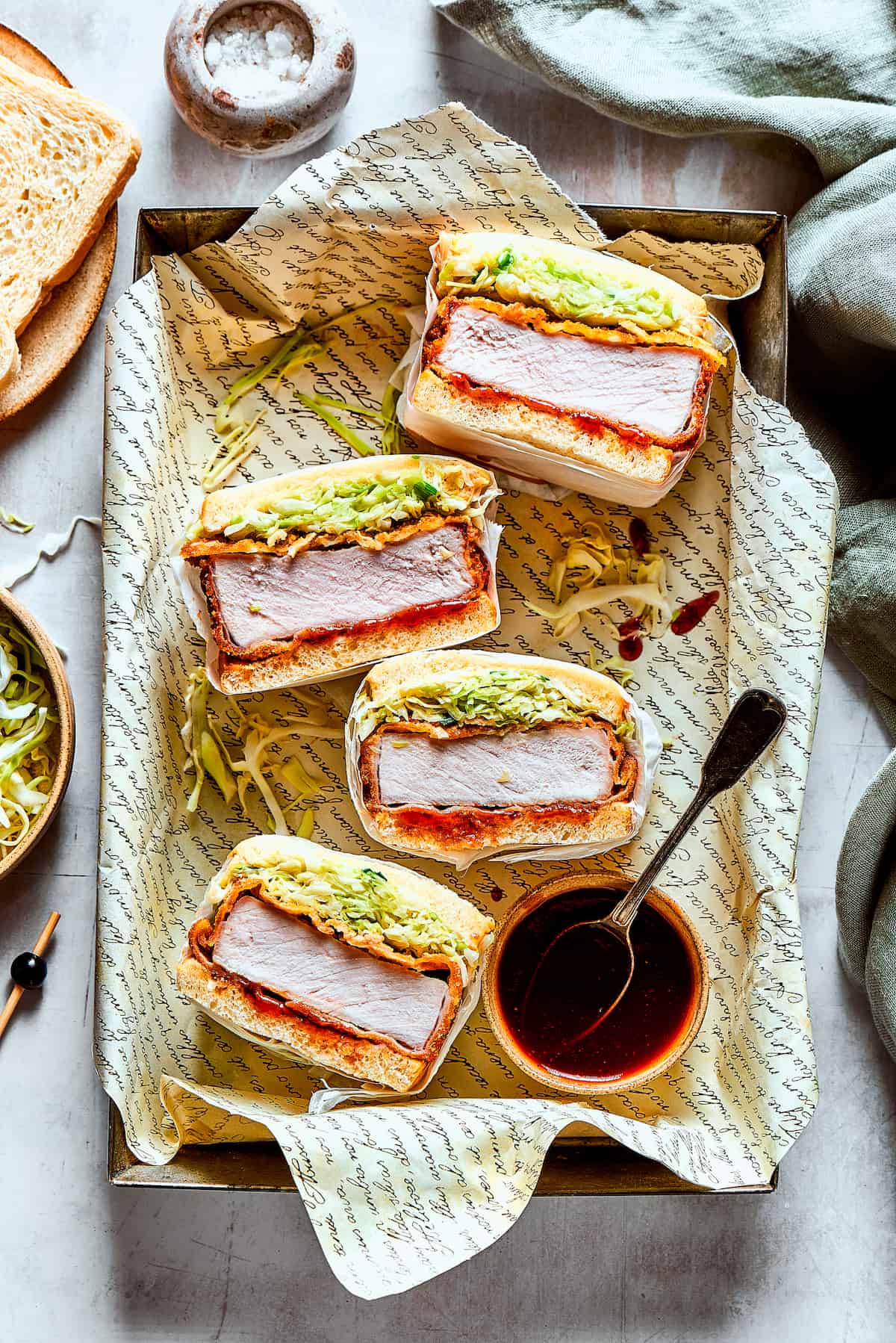 A stack of katsu sandos and tonkatsu sauce.