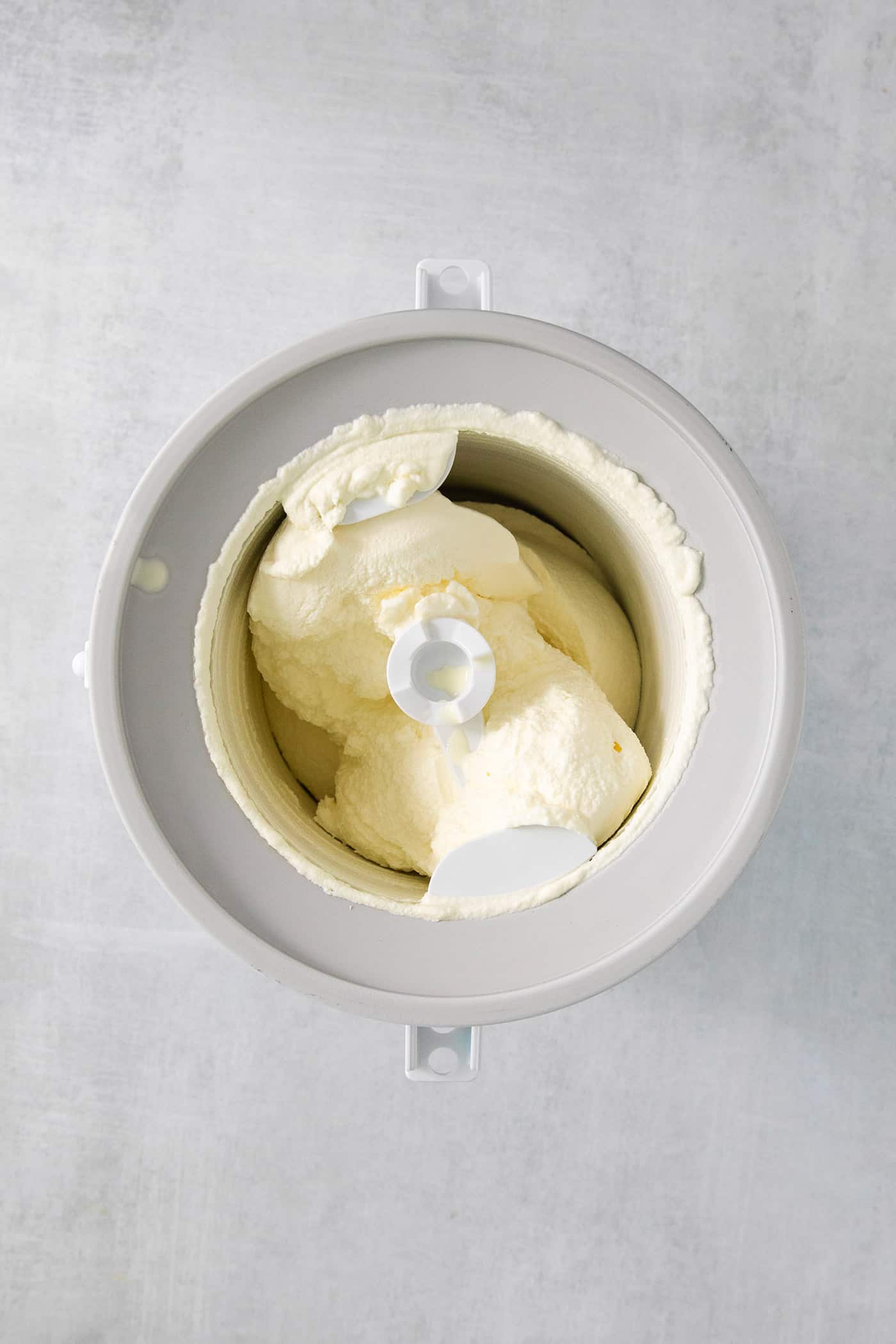 This Birthday Cake Ice Cream is delightfully rich and creamy, with swirls of blue vanilla frosting and sprinkles. No custard required! Ice cream base churns in an ice cream maker.