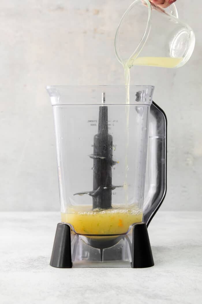 Try a Bootleg Cocktail for a citrus-infused treat of a cocktail! Lemon, lime, and orange juice combine with vodka and mint. Lemon juice is poured into a blemder.