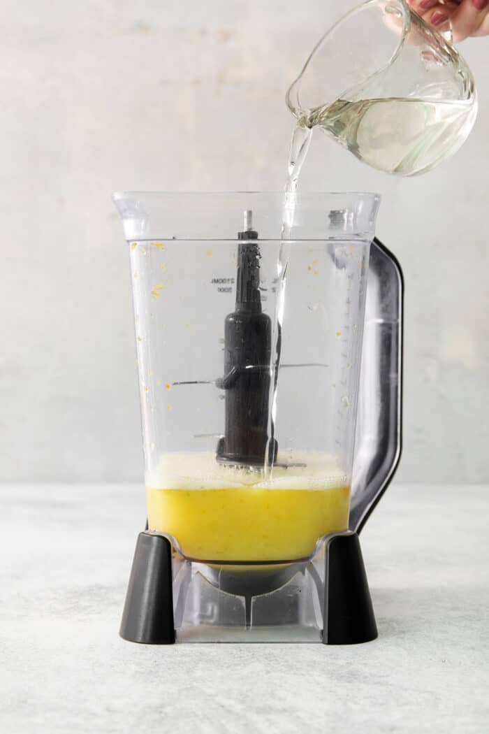 Try a Bootleg Cocktail for a citrus-infused treat of a cocktail! Lemon, lime, and orange juice combine with vodka and mint. Simple syrup is poured into a blender of juice.