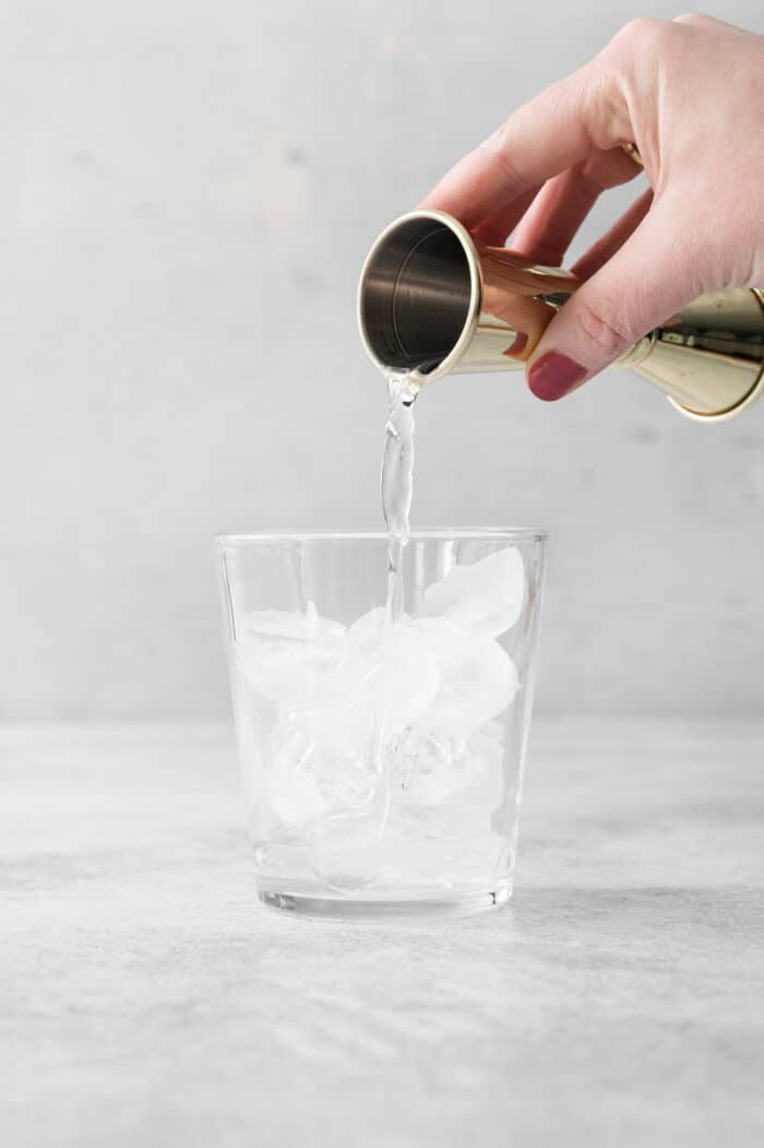 Try a Bootleg Cocktail for a citrus-infused treat of a cocktail! Lemon, lime, and orange juice combine with vodka and mint. Vodka is poured into a glass of ice.