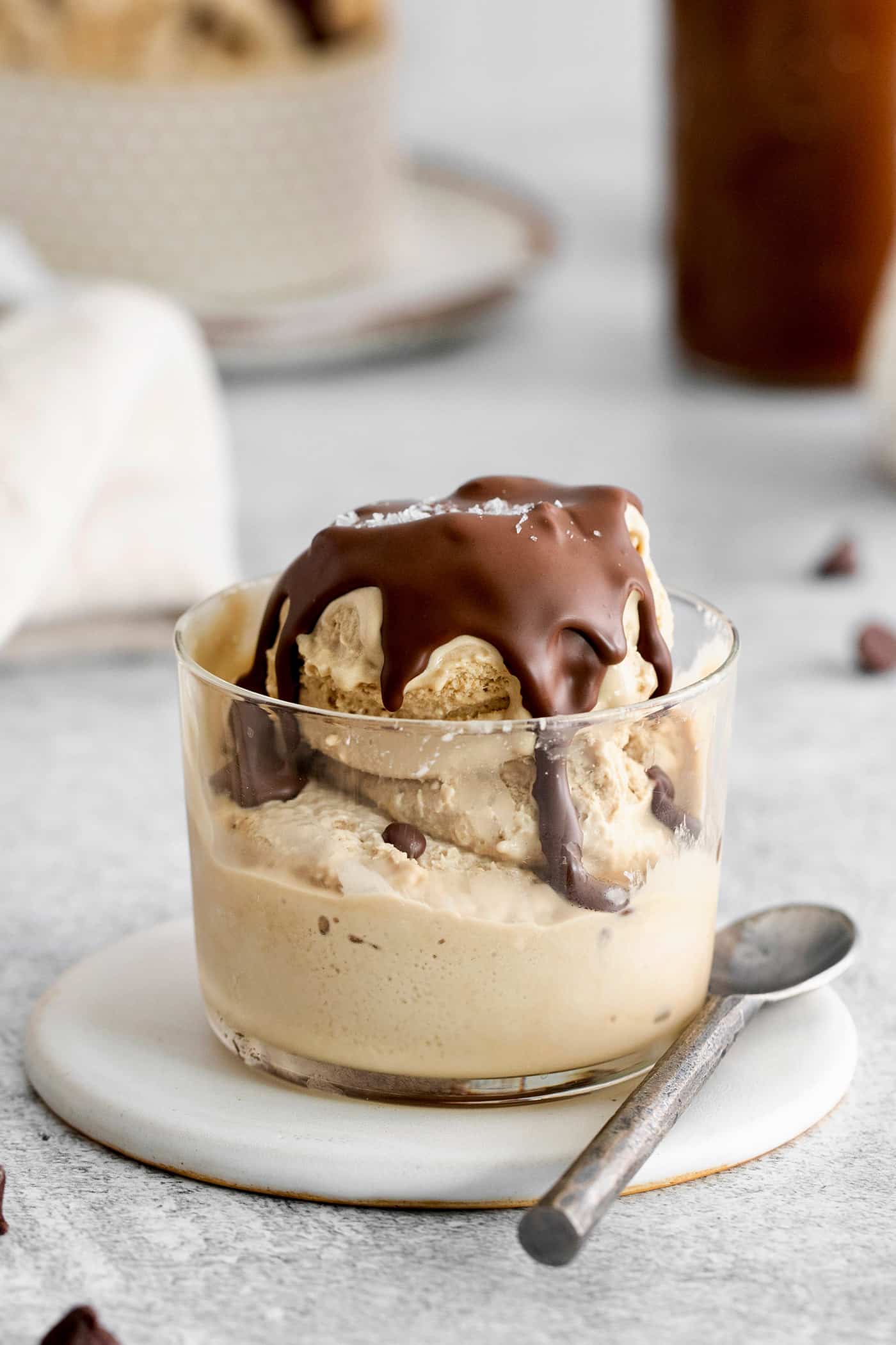 This is the easiest and best Chocolate Magic Shell recipe! Just 3 ingredients melt together to make an amazing topping. A clear bowl of ice cream topped with chocolate magic shell.