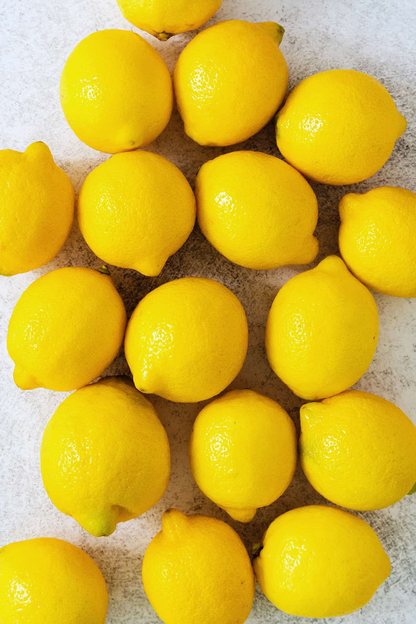 A small glass of this homemade Limoncello, served straight from the freezer, is the loveliest end to a meal. A close up oflemons.