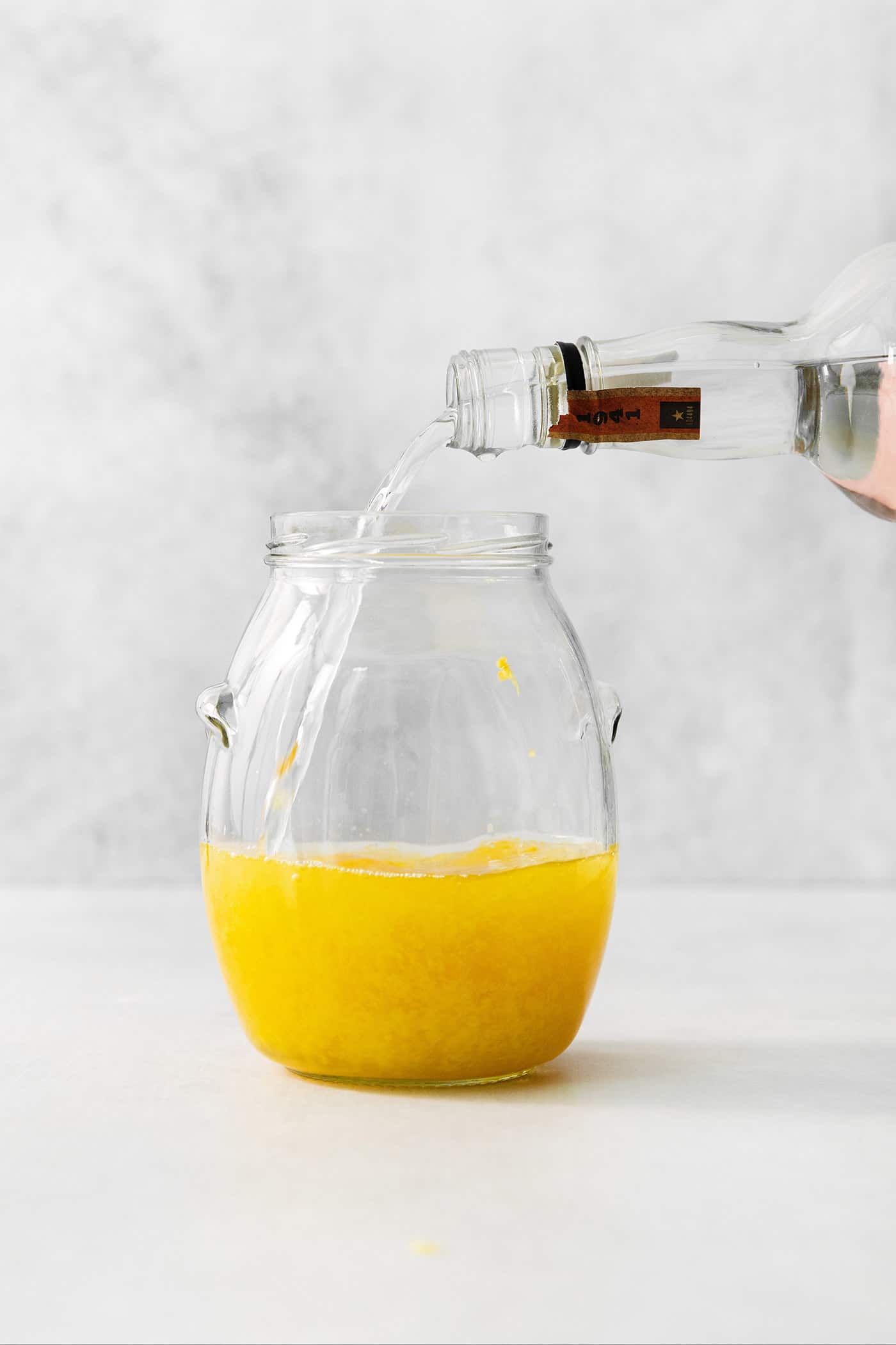 A small glass of this homemade Limoncello, served straight from the freezer, is the loveliest end to a meal. Vodka is poured into a jar of lemon zest to make limoncello.