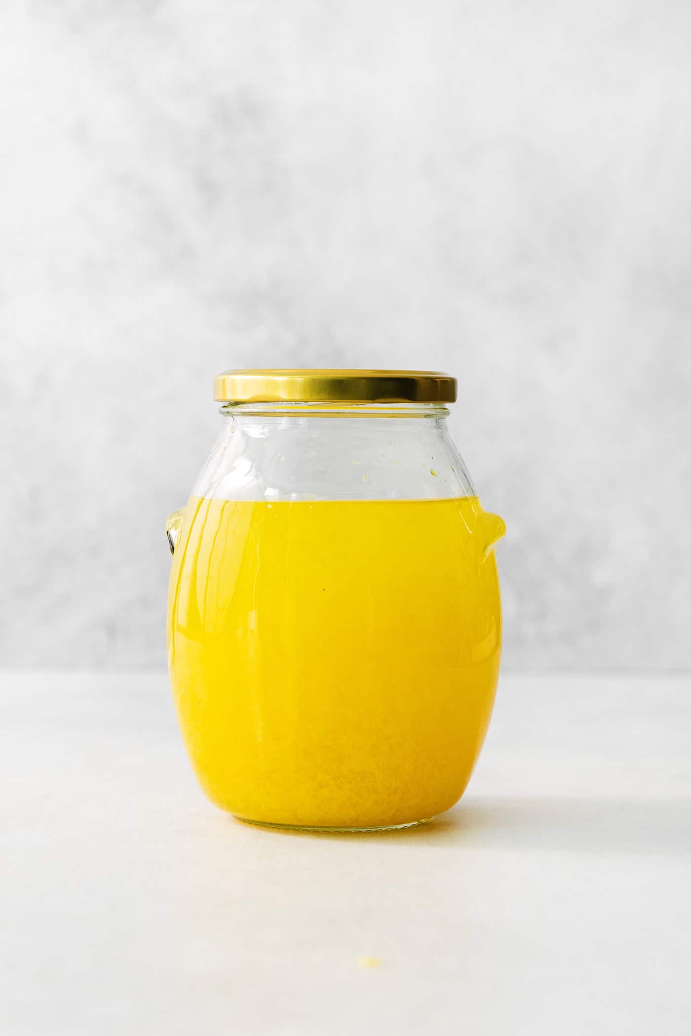 A small glass of this homemade Limoncello, served straight from the freezer, is the loveliest end to a meal. A jar of lemon zest and vodka.