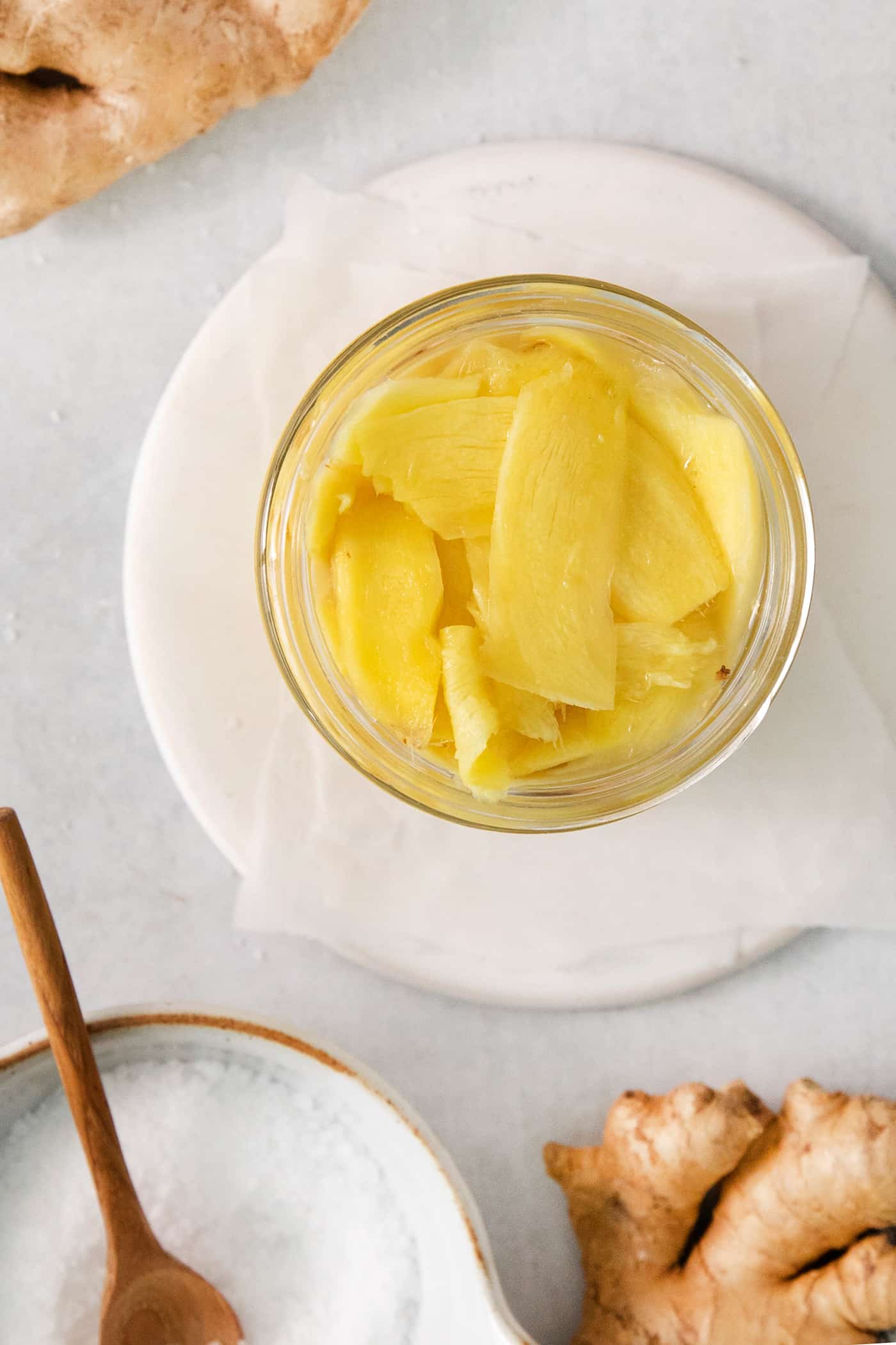 Peppery, pink Pickled Ginger is a wonderful companion to sushi and it's so easy to make at home! You need just 5 ingredients. Pickled ginger is shown in a jar.