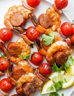 A close up of shrimp and sausage kabobs.