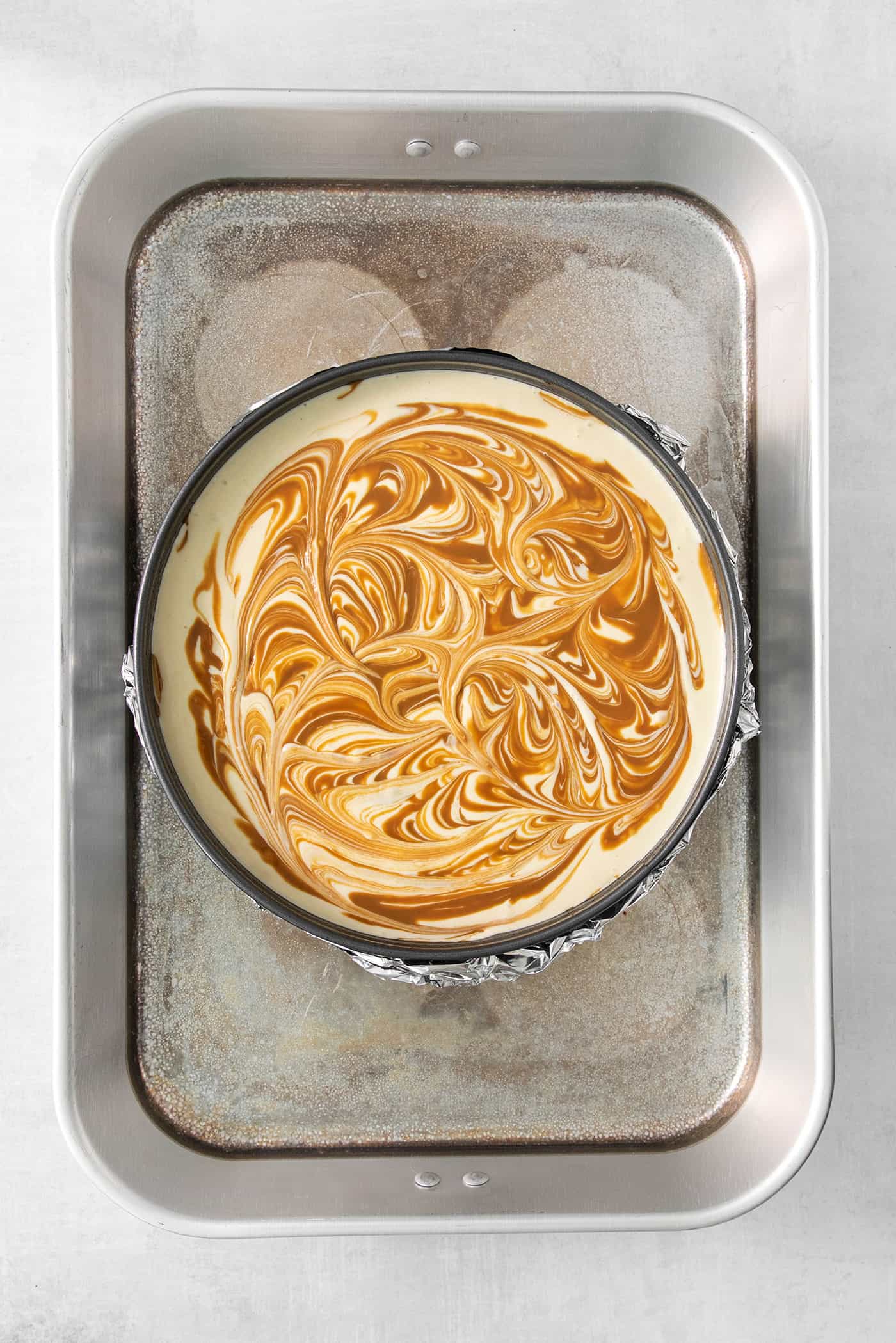 This Biscoff Cheesecake balances a rich cream cheese layer swirled with Biscoff cookie butter on a buttery cookie crust. Cookie butter is swirled into a cheesecake base.