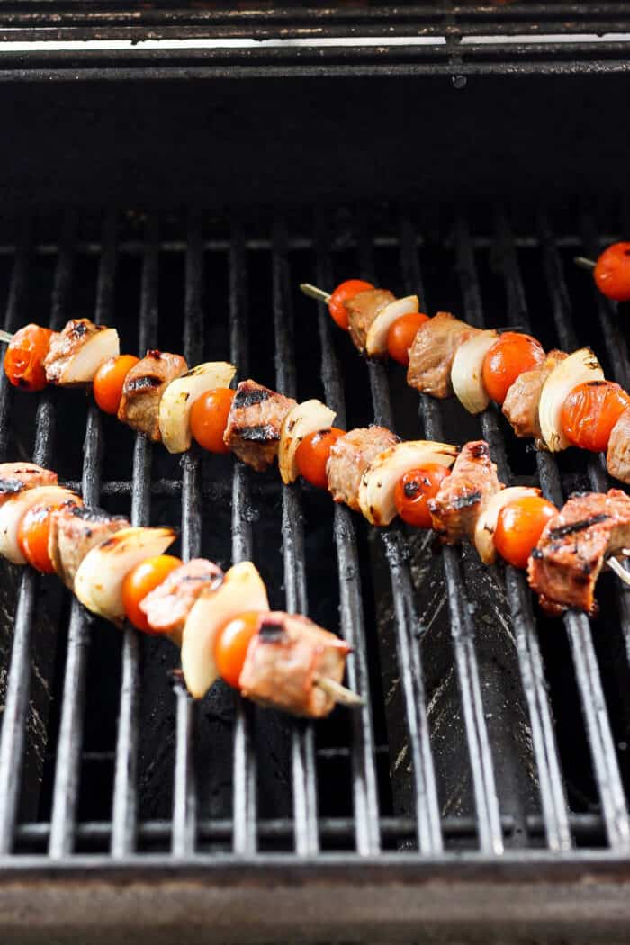 These tender Chicken Kabobs with Rapes are marinated in a lemon yogurt sauce and paired with honey balsamic shallots and sweet juicy grapes. Skewers of honey mustard beef kabobs with vegetables are shown cooking on a grill.
