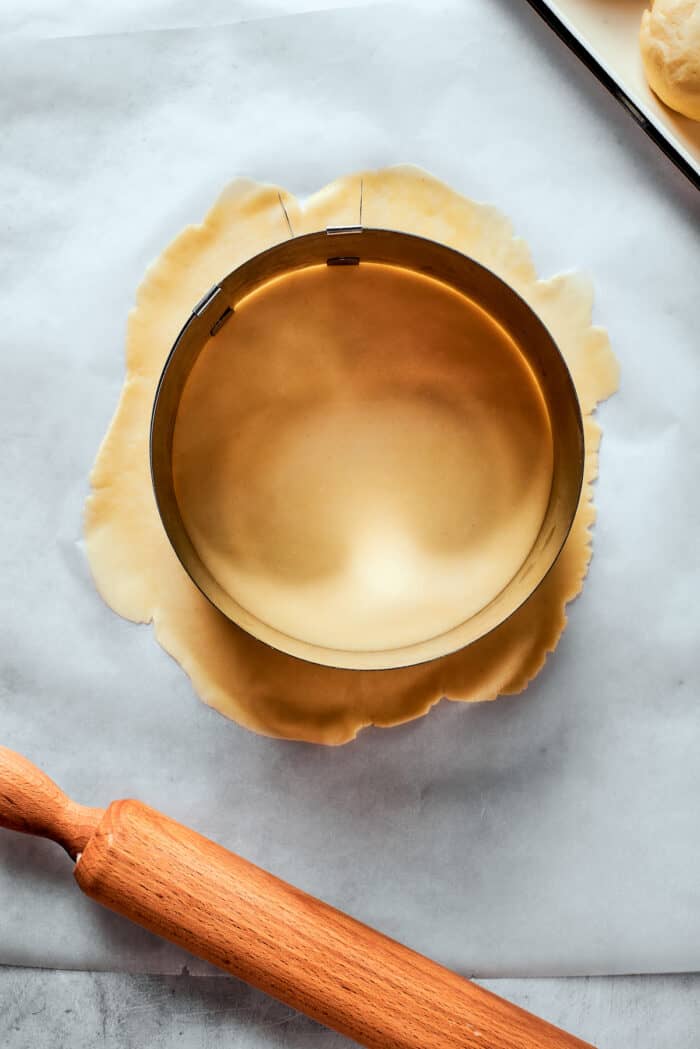 Napoleon Cake takes flaky homemade pastry and layers it with a sumptuous egg custard to make a creamy and cool dessert! A pastry round sits on top of pastry dough.