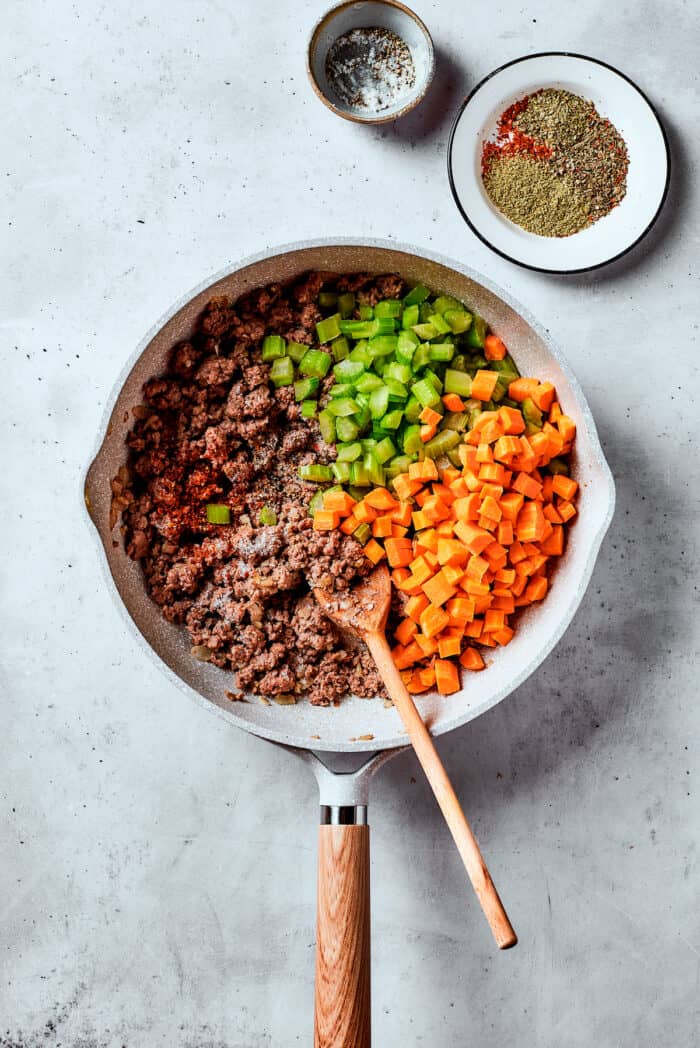 Easy, Italian-inspired Pasta Fazool is a wonderful soup that pairs creamy white beans with ground meat and pasta in a tomato-based broth. Carrots and celery are added to meat in a skillet.