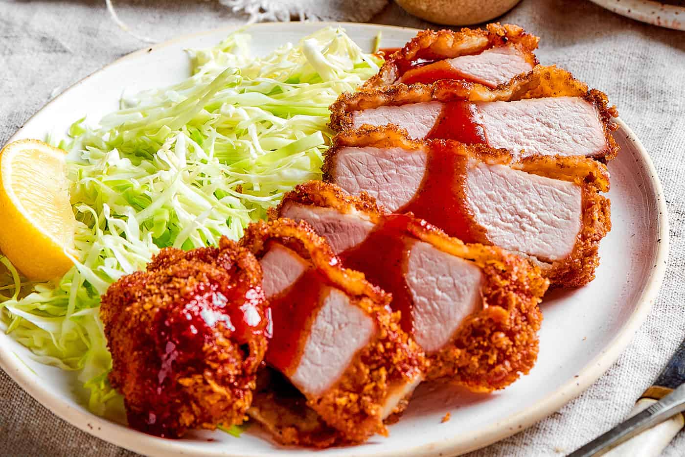 sliced pork katsu and cabbage on a plate