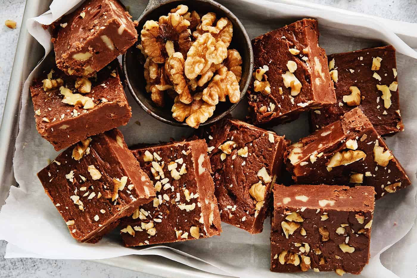 A tray of Fantasy Fudge is shown with walnuts above it.
