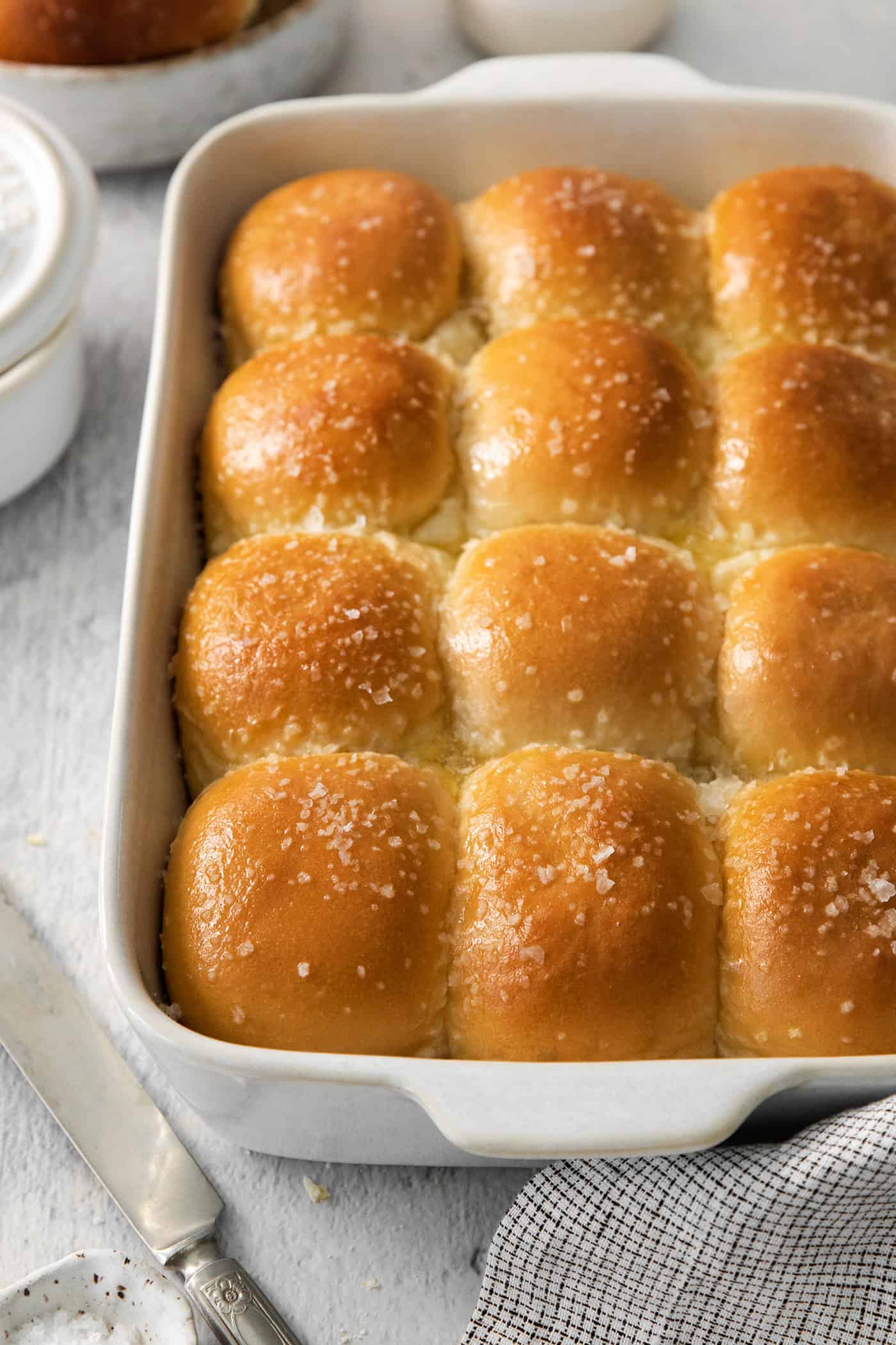 These copycat Rhodes Rolls are light and fluffy with a tender crumb and delicate flavor. Perfect for holiday meals! A pan of baked rhodes rolls.