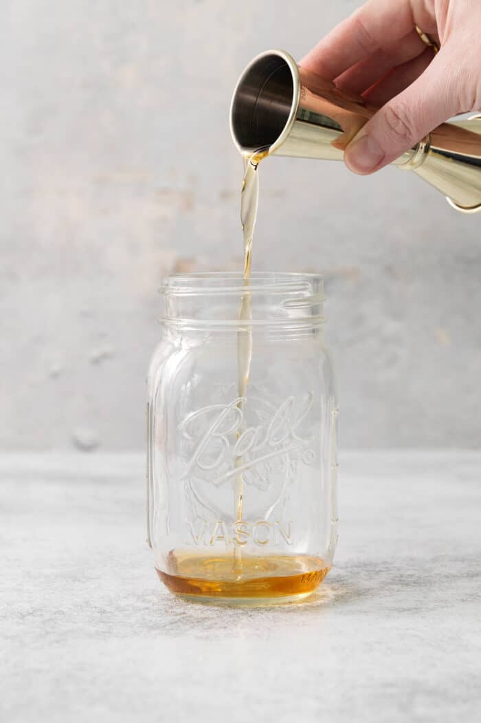 This Salted Nut Roll Shot is a fantastic twist on the salted nut roll candy bar with Rumchata, peanut butter whiskey, and vanilla vodka. Whiskey is poured into a mason jar.