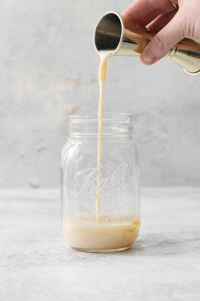 This Salted Nut Roll Shot is a fantastic twist on the salted nut roll candy bar with Rumchata, peanut butter whiskey, and vanilla vodka. Rumchata is poured into a mason jar.
